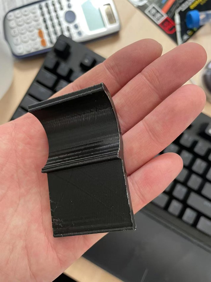 Black v1 mount held in hand, curved with a display pocket