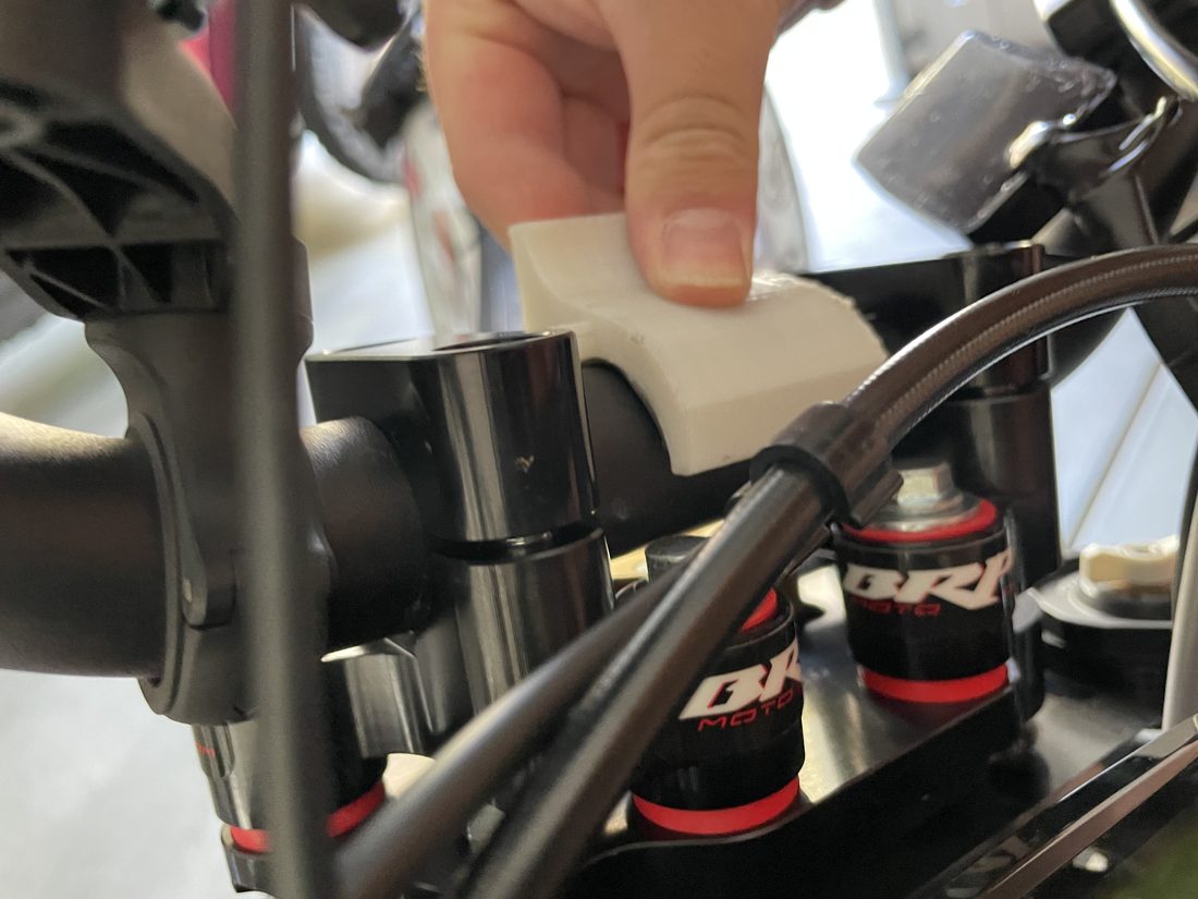 White v2 mount being fitted to the handlebar