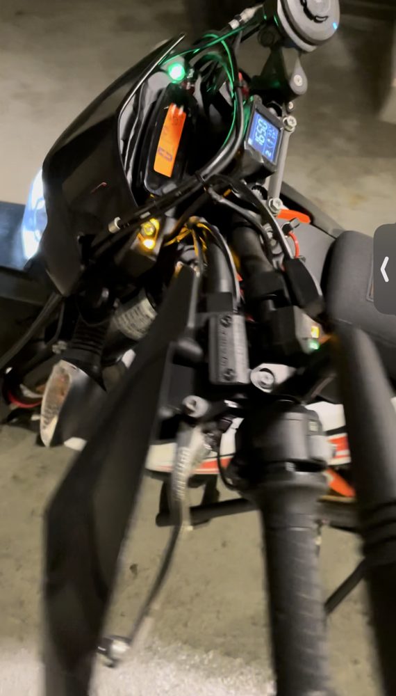 Trip computer mounted on the bike with the display lit